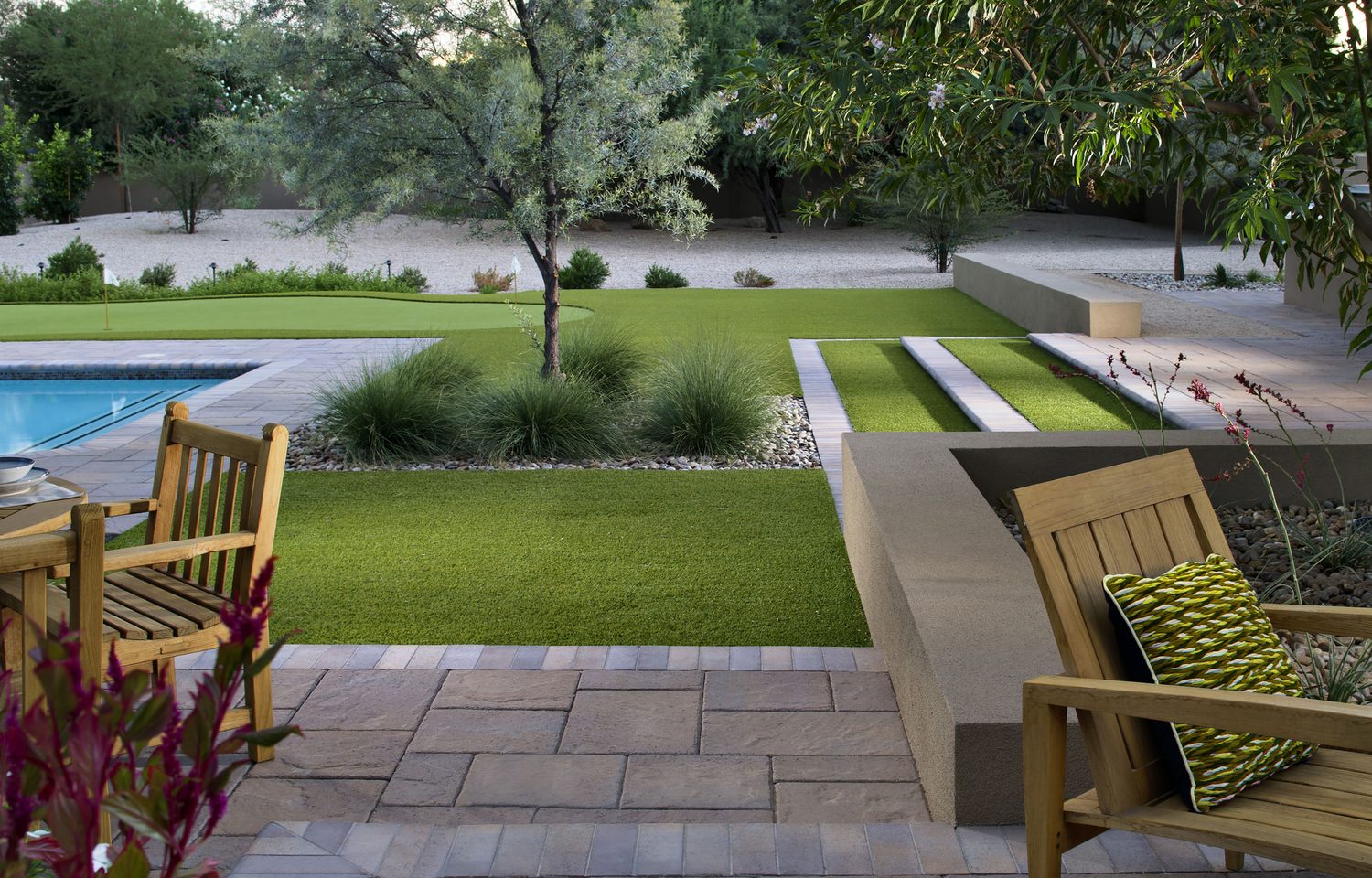 Well-maintained artificial grass garden with pool