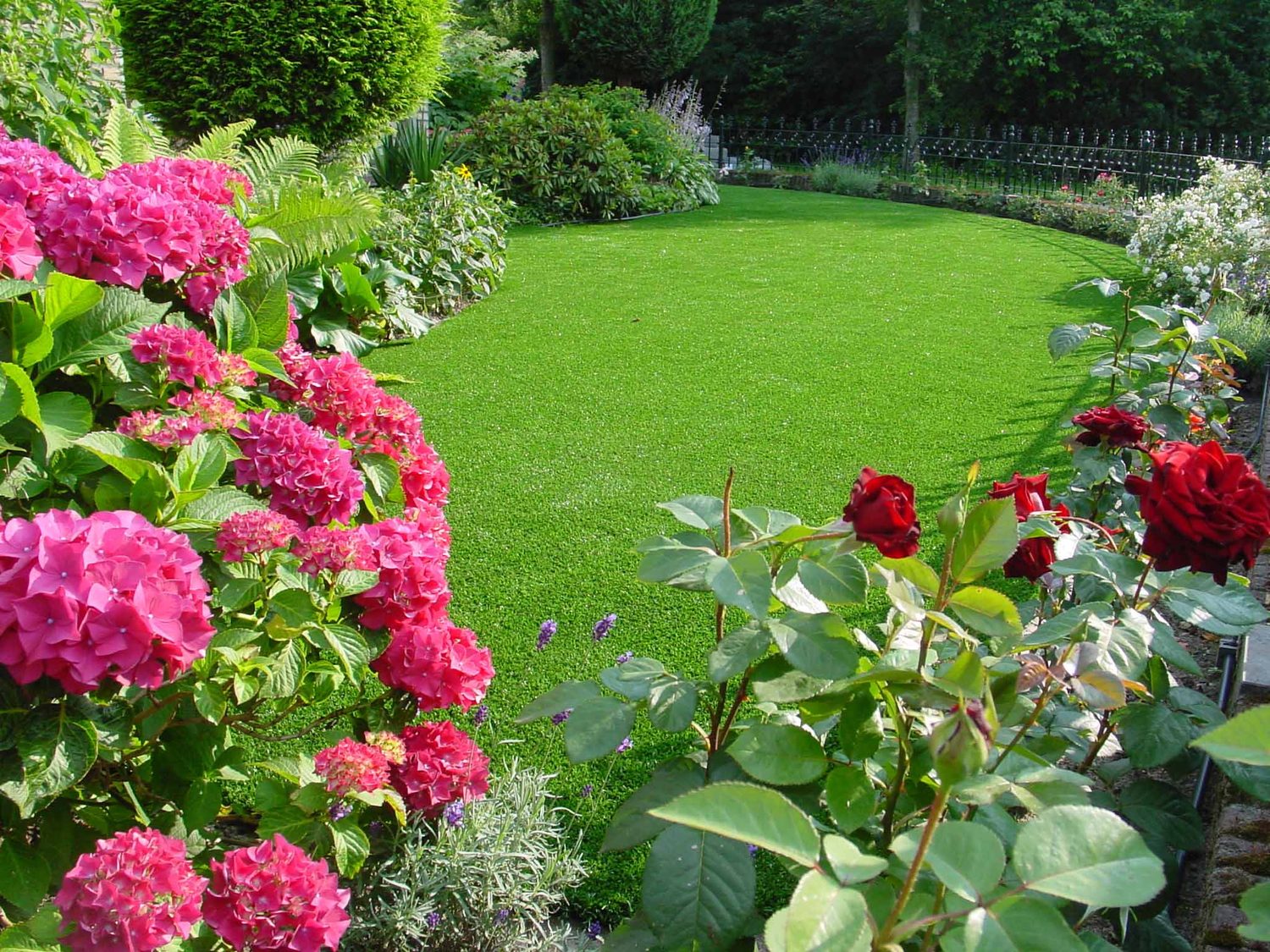Lush garden with artificial grass and flowers